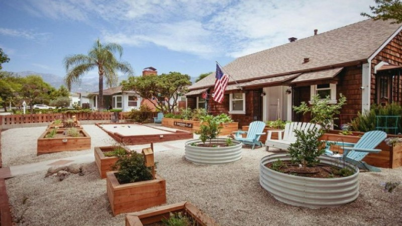 Charming backyard with raised garden beds, seating, and American flag